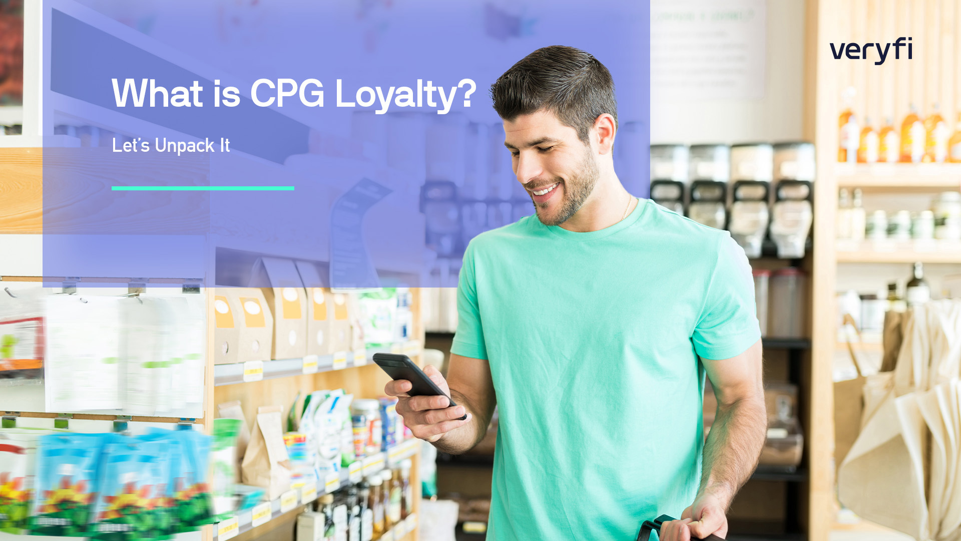 A CPG loyalty male customer at the grocery story smiling and looking at his mobile phone.
